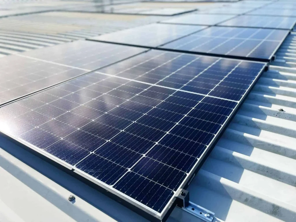 Solar panels installed on industrial rooftop generating renewable energy