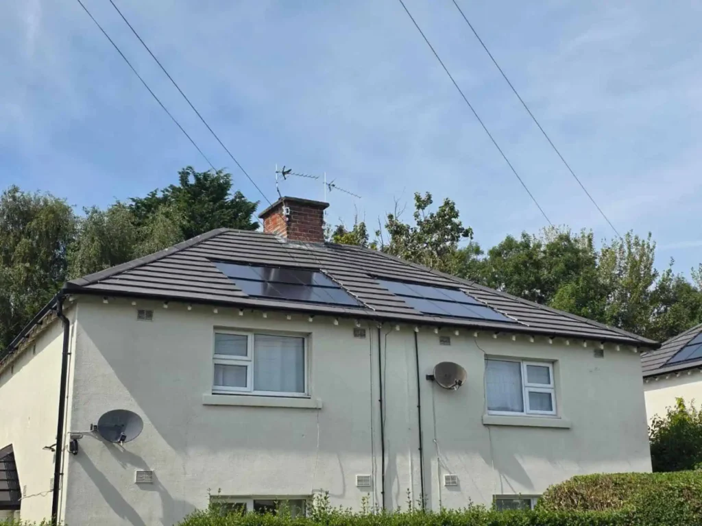White bungalow with solar panels on dark roof