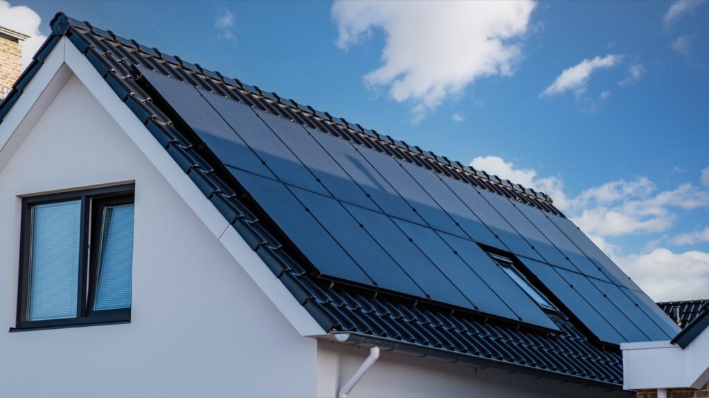 Home with rooftop solar panels on a sunny day